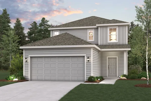 a front view of a house with a garden and garage