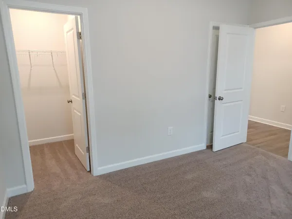 an empty room with closet area