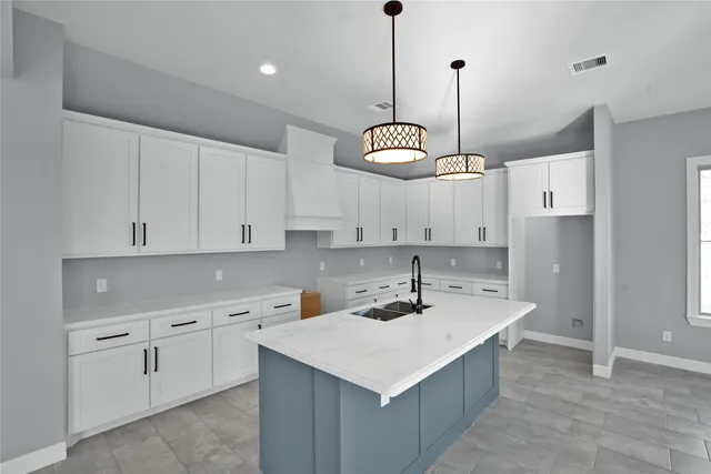 a kitchen with kitchen island white cabinets and white appliances