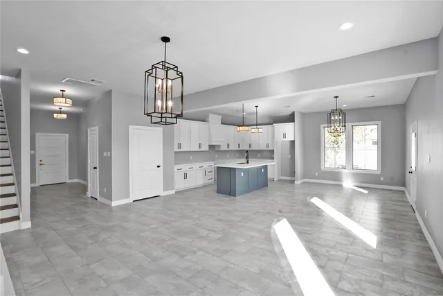 a view of a kitchen with a sink and cabinets