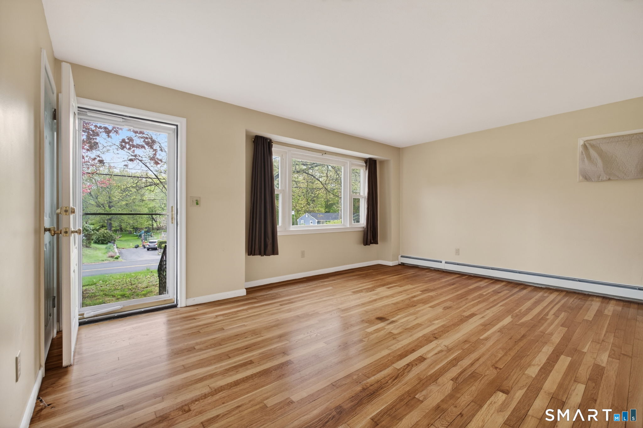 121 Cherry Hill Road Middlefield, CT 06455 - Photo 12 of 40 a view of an empty room with wooden floor and a window