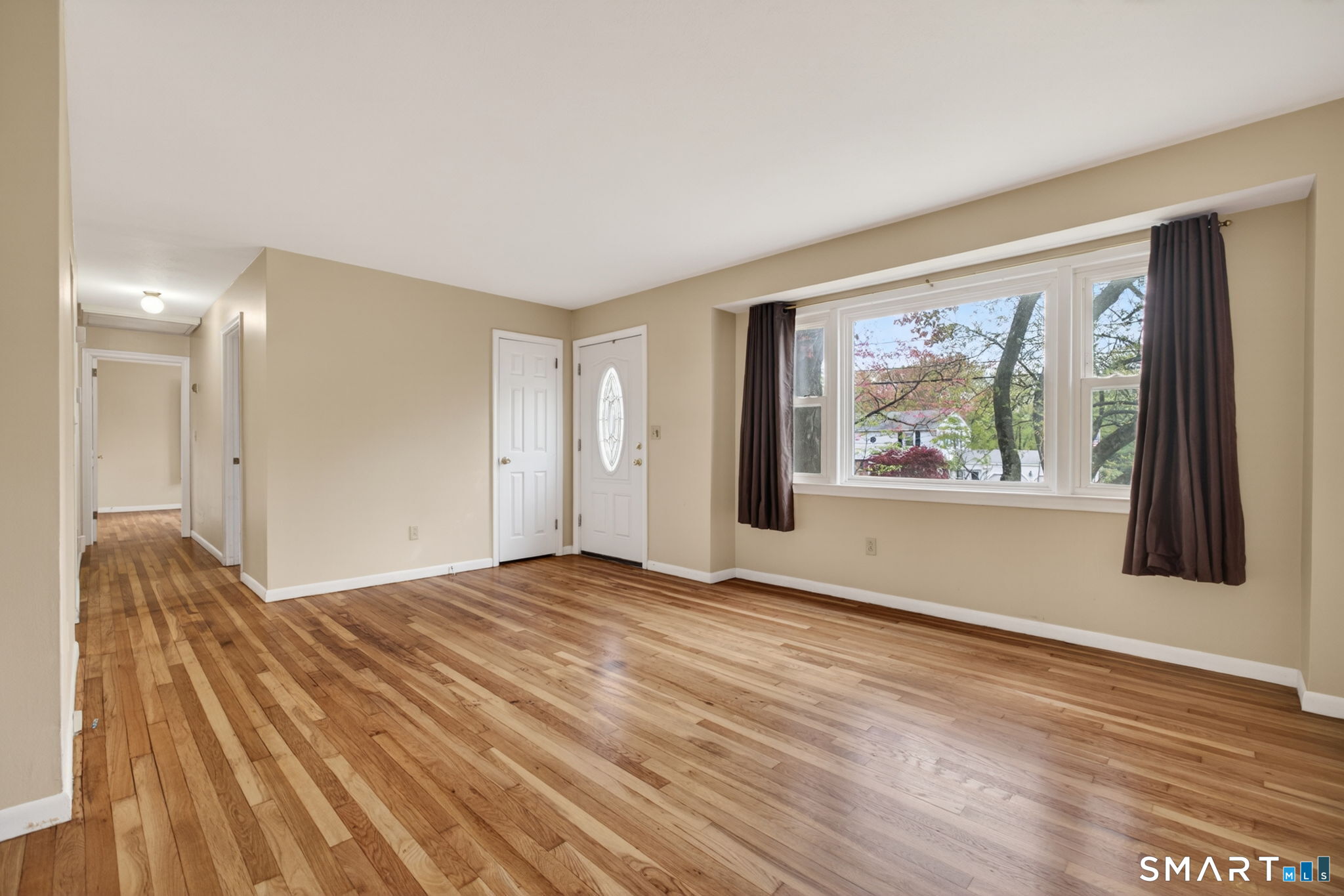 121 Cherry Hill Road Middlefield, CT 06455 - Photo 13 of 40 a view of an empty room with painting on the wall and a window