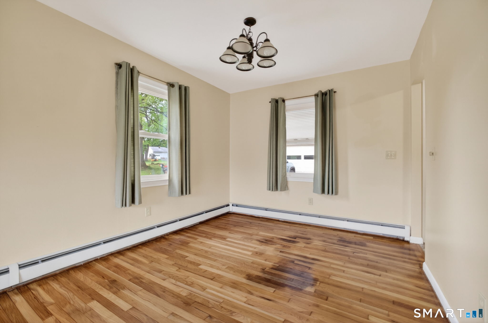 121 Cherry Hill Road Middlefield, CT 06455 - Photo 16 of 40 a view of an empty room with wooden floor and a window