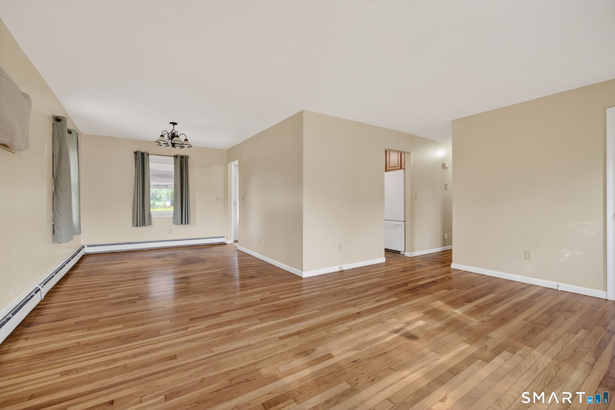 121 Cherry Hill Road Middlefield, CT 06455 - Photo 18 of 40 a view of an empty room with window and wooden floor