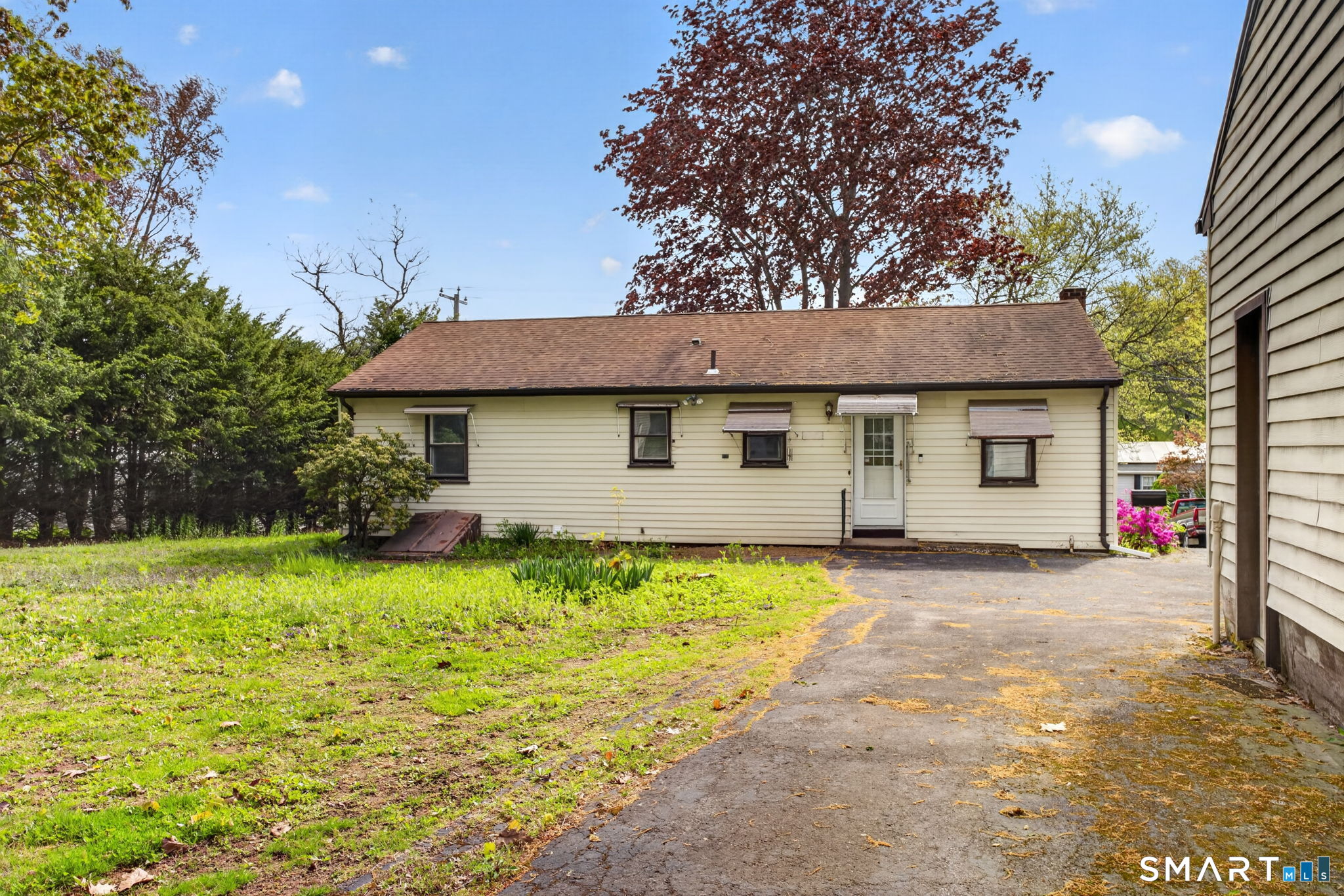 121 Cherry Hill Road Middlefield, CT 06455 - Photo 33 of 40 a front view of a house with a garden and trees