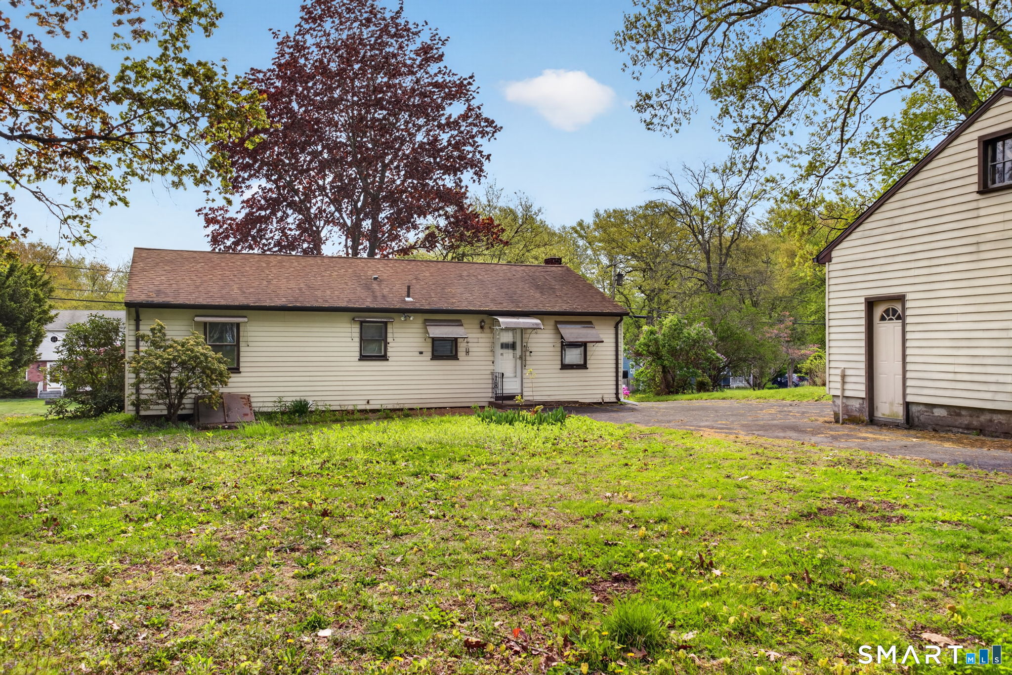 121 Cherry Hill Road Middlefield, CT 06455 - Photo 36 of 40 a front view of a house with a garden and yard