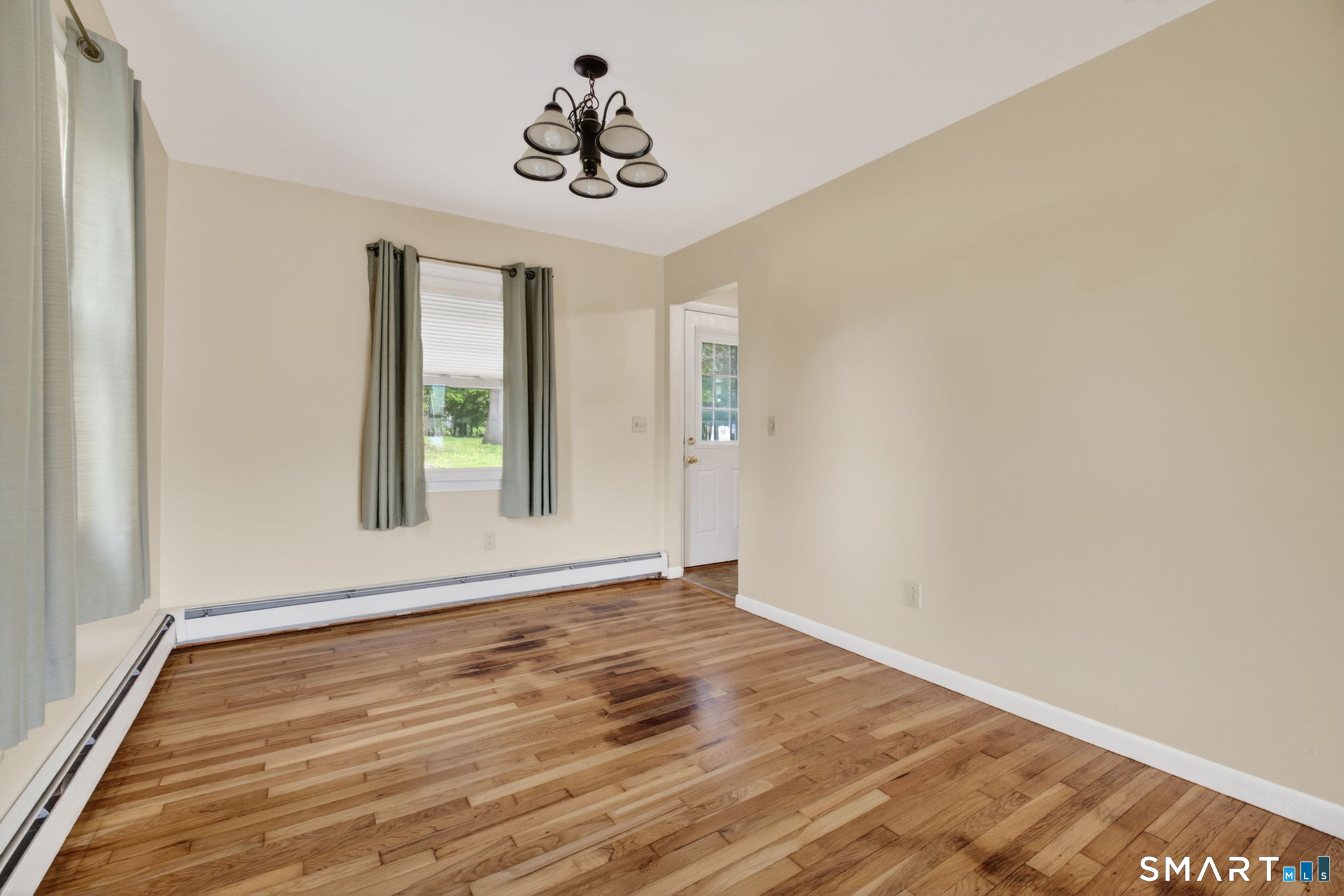 121 Cherry Hill Road Middlefield, CT 06455 - Photo 9 of 40 a view of an empty room with wooden floor and a window