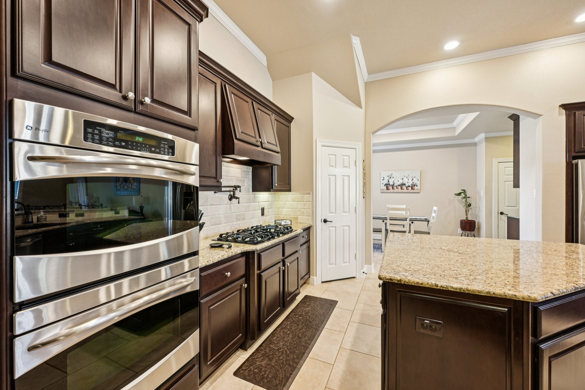 25214 East Titan Springs Drive Spring, TX 77389 - Photo 16 of 44 a kitchen with stainless steel appliances and granite countertop stove top oven