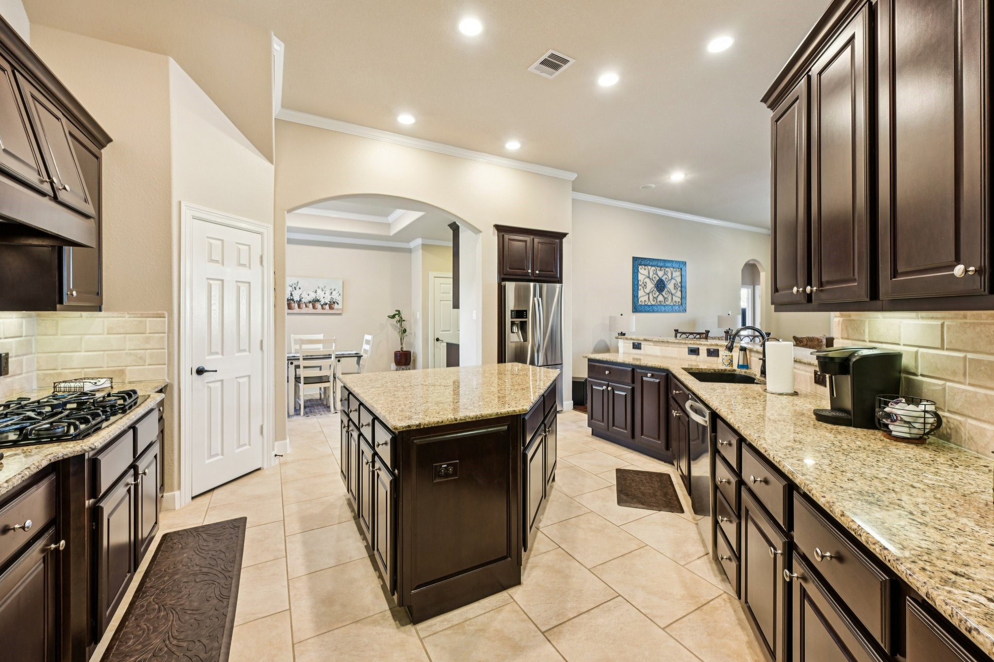 25214 East Titan Springs Drive Spring, TX 77389 - Photo 17 of 44 a kitchen with stainless steel appliances granite countertop a sink a stove and a refrigerator