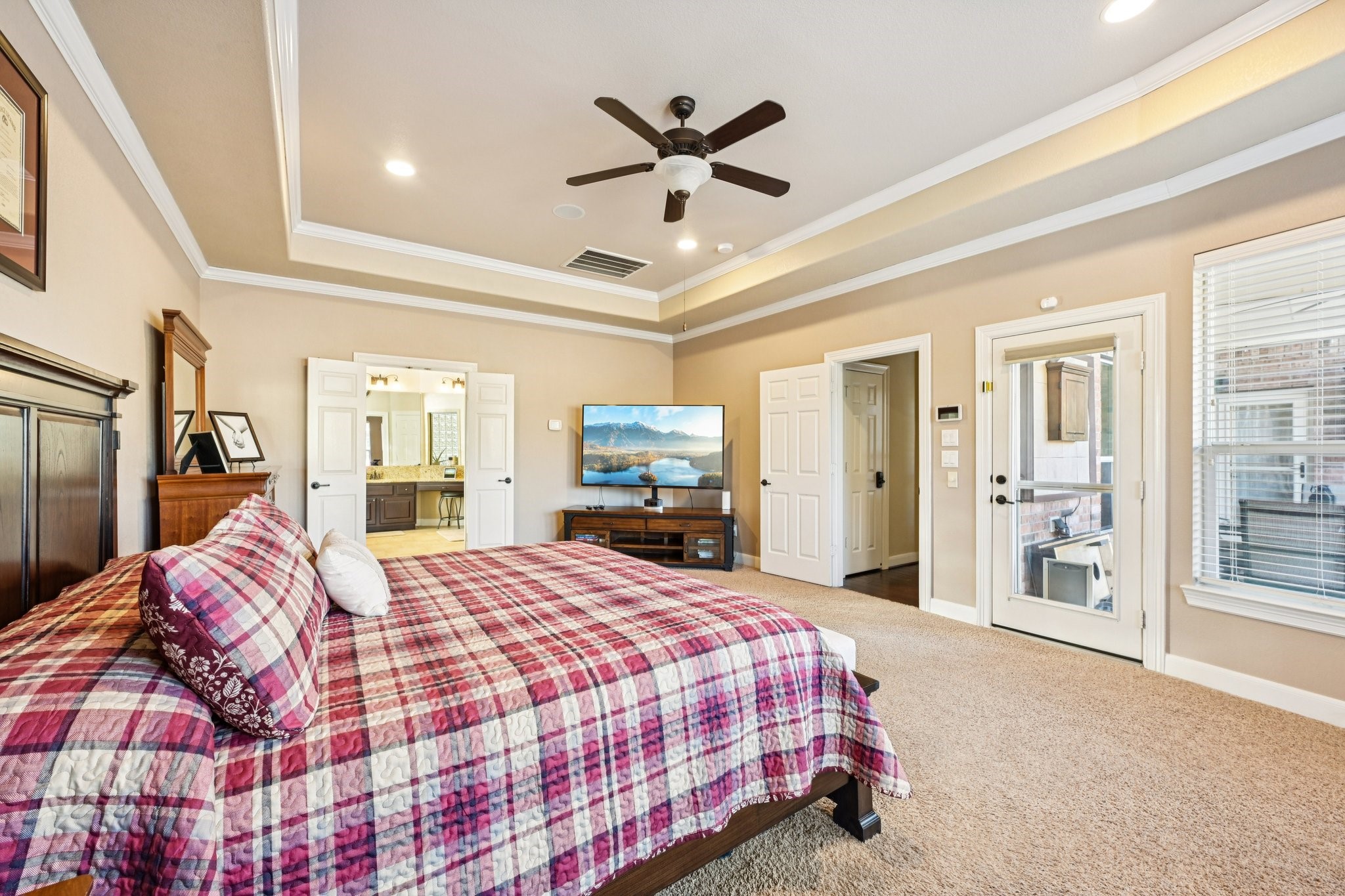 25214 East Titan Springs Drive Spring, TX 77389 - Photo 25 of 44 a bedroom with a large bed and a chandelier