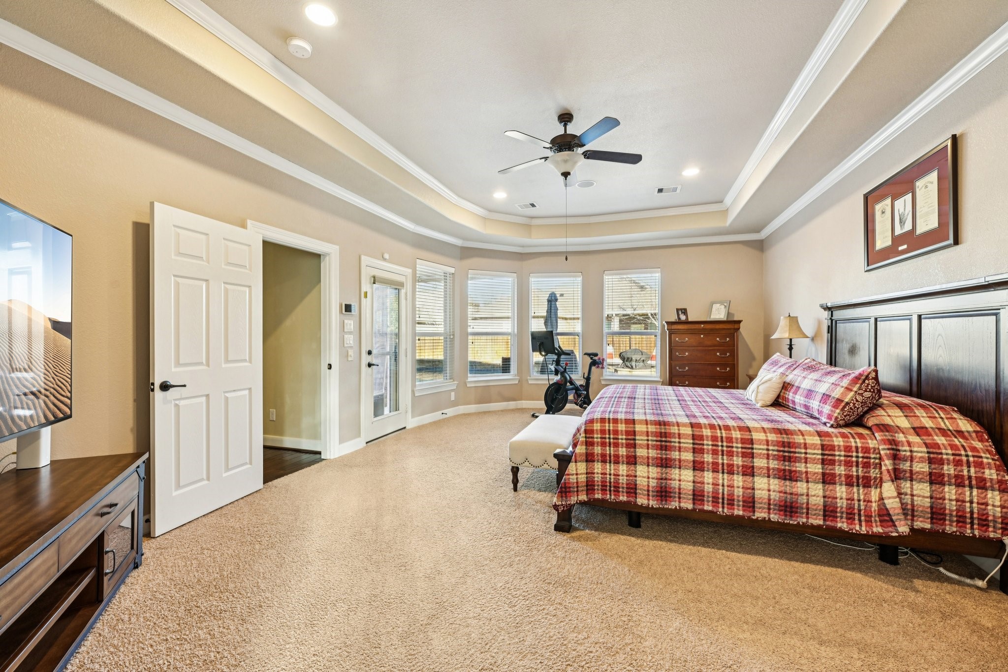 25214 East Titan Springs Drive Spring, TX 77389 - Photo 26 of 44 a bedroom with a large bed and a chandelier