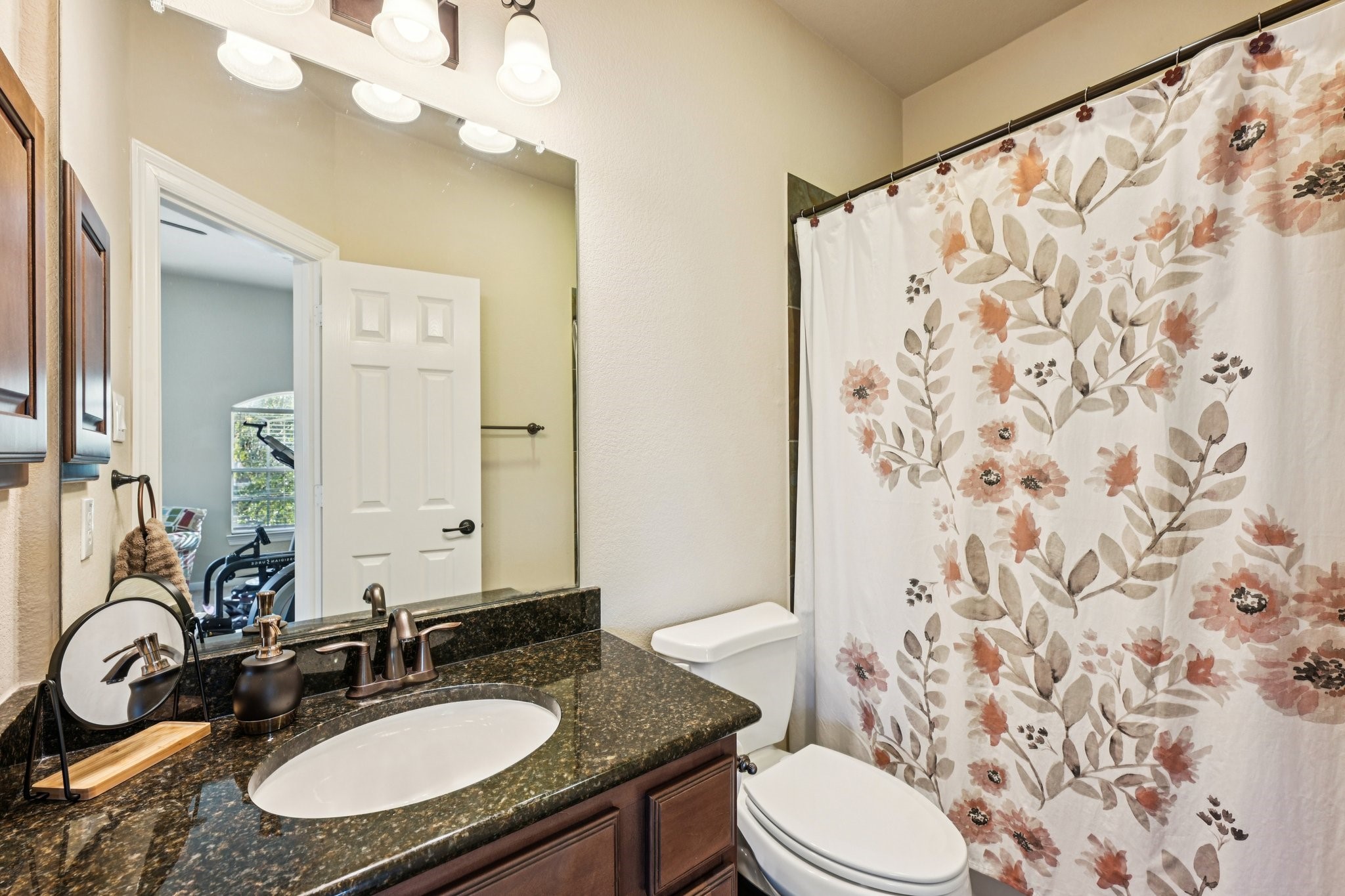25214 East Titan Springs Drive Spring, TX 77389 - Photo 37 of 44 a bathroom with a sink toilet a mirror and shower curtain