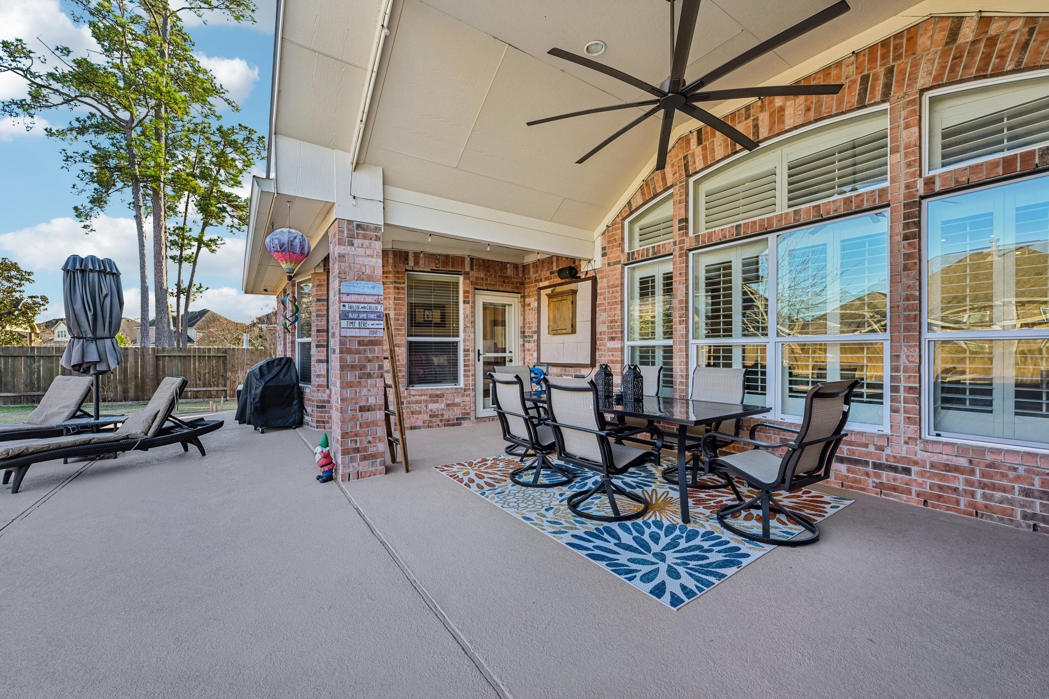 25214 East Titan Springs Drive Spring, TX 77389 - Photo 39 of 44 a view of a patio with table and chairs and a potted plant