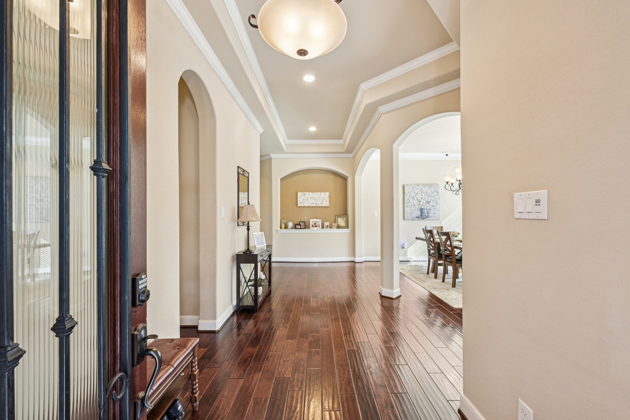 25214 East Titan Springs Drive Spring, TX 77389 - Photo 6 of 44 a view of a hallway with wooden floor and a chandelier
