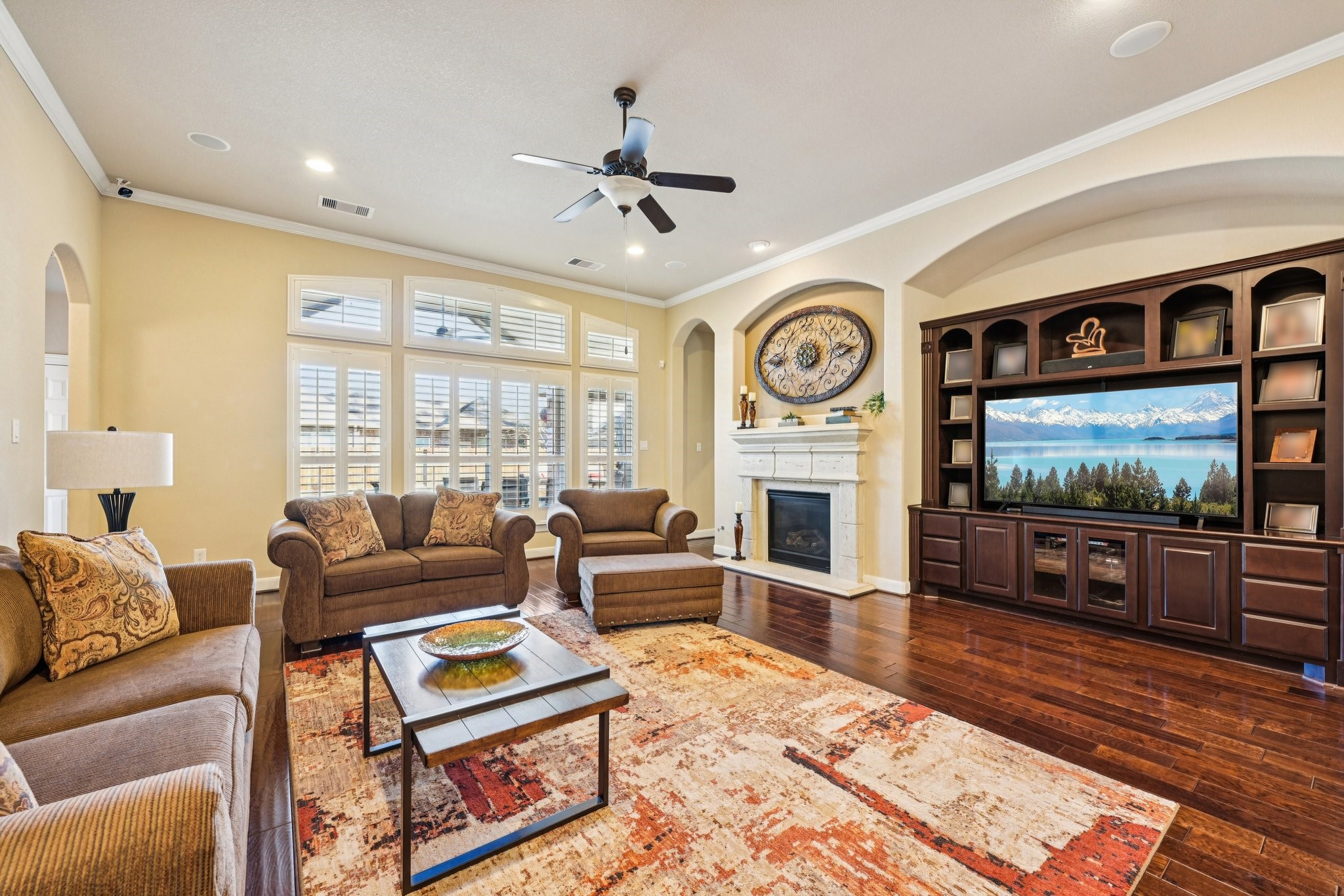 25214 East Titan Springs Drive Spring, TX 77389 - Photo 8 of 44 a living room with furniture a flat screen tv and a fireplace