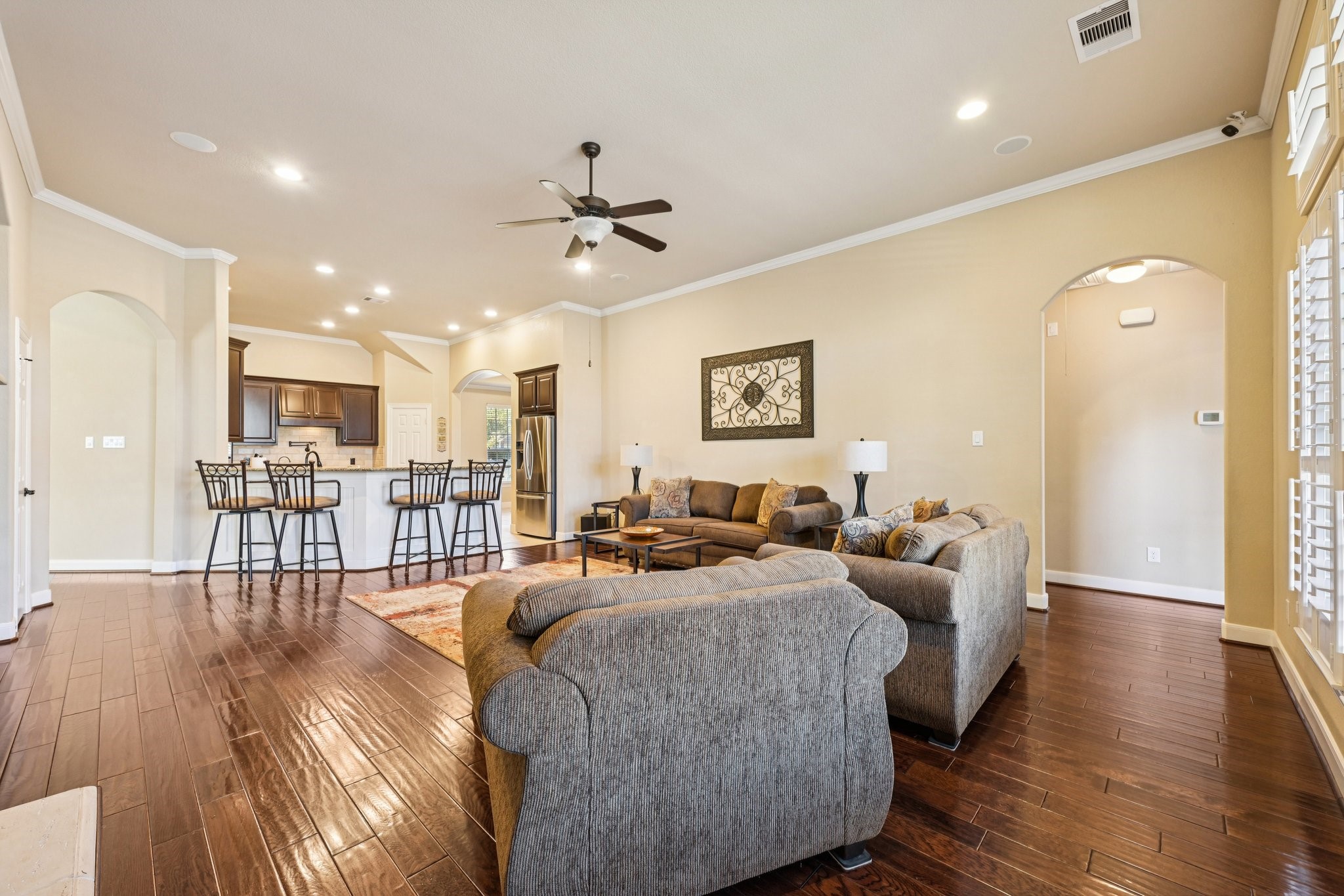 25214 East Titan Springs Drive Spring, TX 77389 - Photo 10 of 44 a living room with furniture a wooden floor and a chandelier