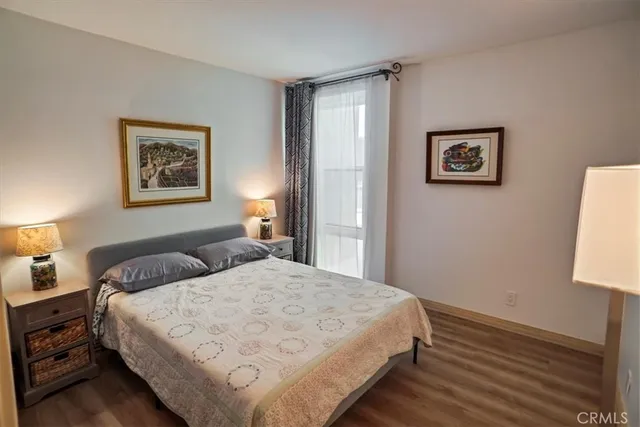 a bedroom with a bed and a night stand