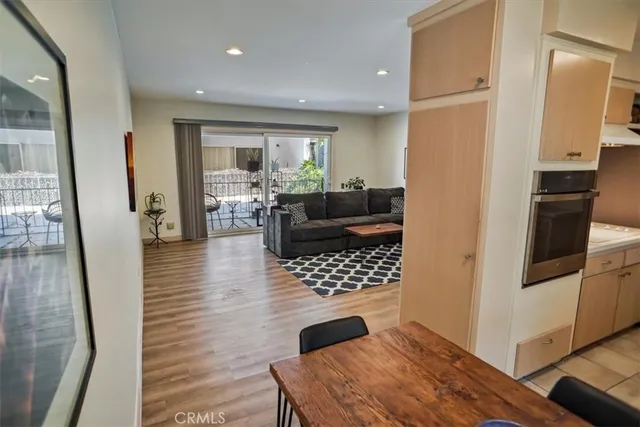 a living room with furniture fireplace and a large window