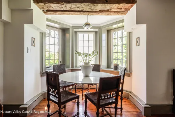 a living room with furniture a rug a fireplace and a window