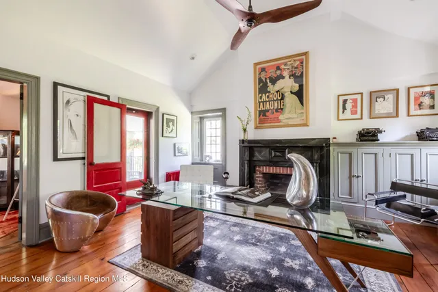 a living room with furniture and floor to ceiling windows