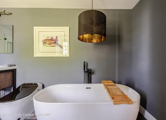 a bathroom with a sink a mirror and a shower