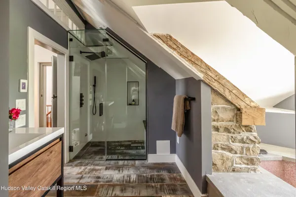 a view of swimming pool with lawn chairs and plants