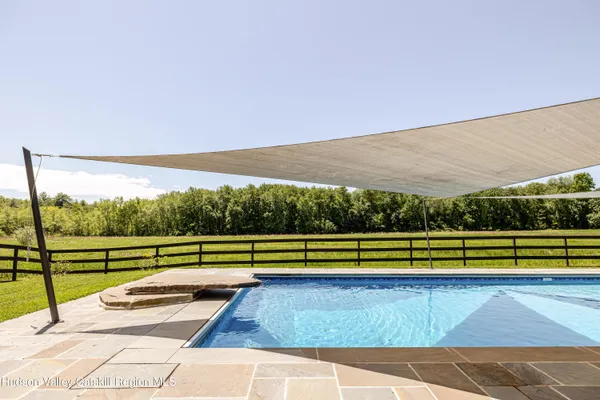 a roof deck with table and chairs a barbeque and potted plants