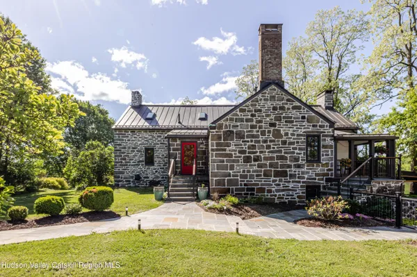 a dining room with furniture water view and a floor to ceiling window