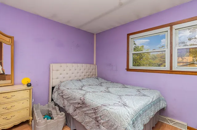 a bedroom with a bed and a dresser