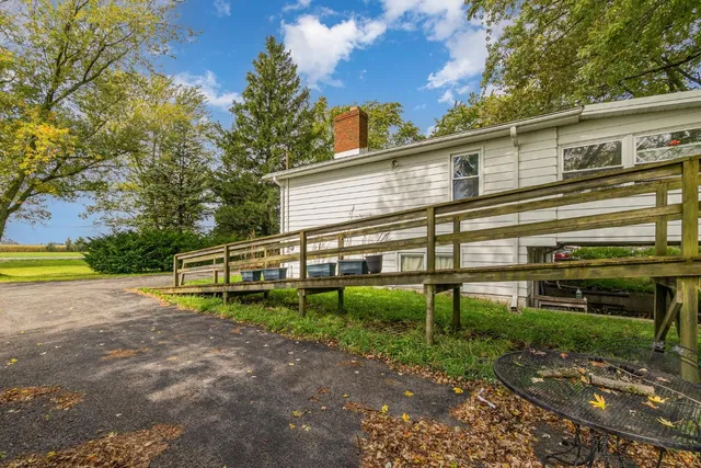 a view of a house with a yard and sitting area