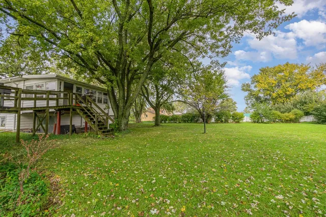 a view of a backyard with large trees