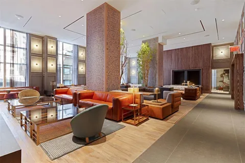 a living room with fireplace furniture and a large window