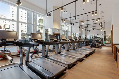 a gym area with lots of gym equipment