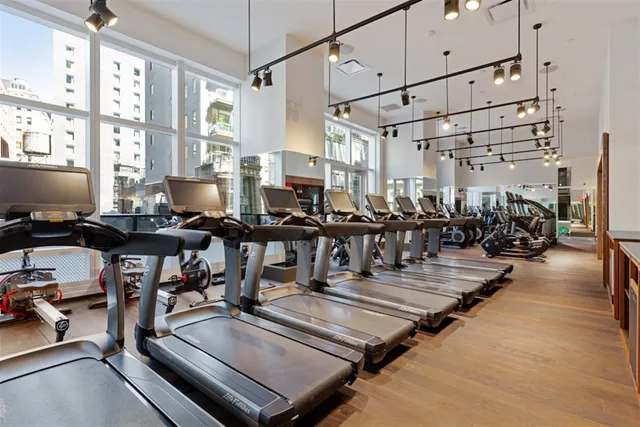 a gym area with lots of gym equipment