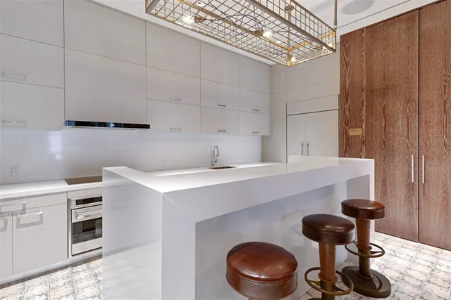 a kitchen with a sink a stove and cabinets