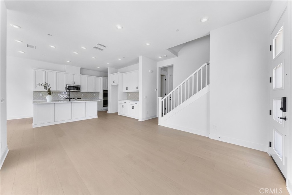 123 Bosal Irvine, CA 92618 - Photo 12 of 75 a view of a kitchen with wooden floor and electronic appliances
