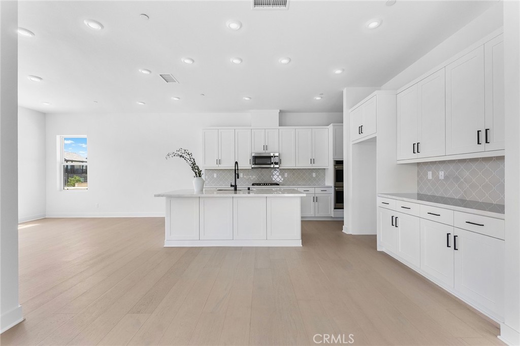 123 Bosal Irvine, CA 92618 - Photo 14 of 75 a kitchen with stainless steel appliances white cabinets and a refrigerator