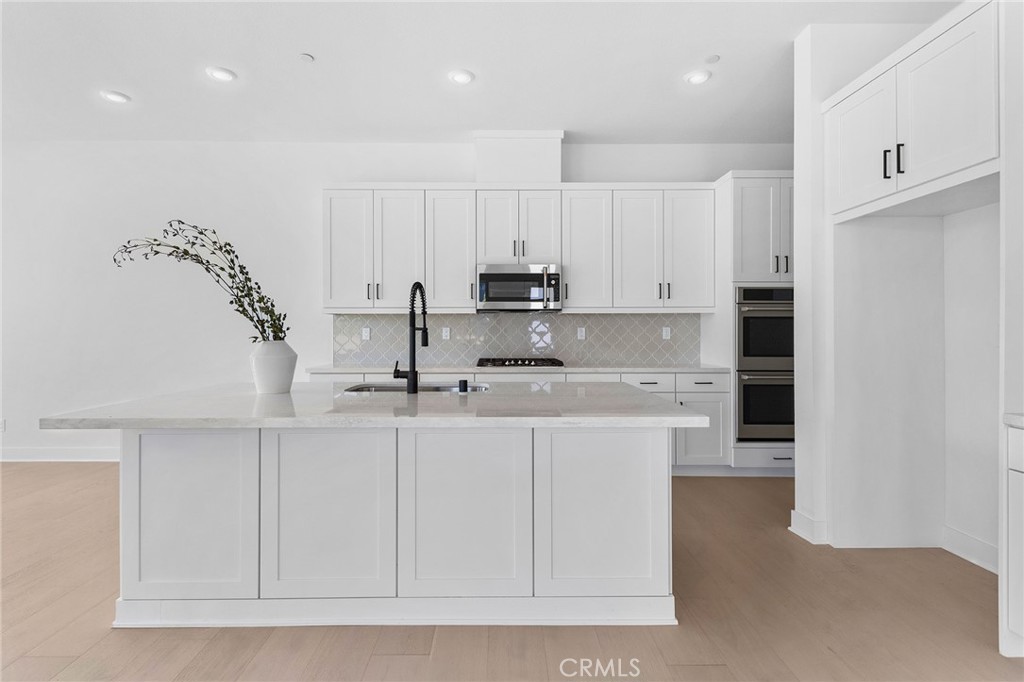 123 Bosal Irvine, CA 92618 - Photo 15 of 75 a kitchen with stainless steel appliances granite countertop a sink a stove and a refrigerator