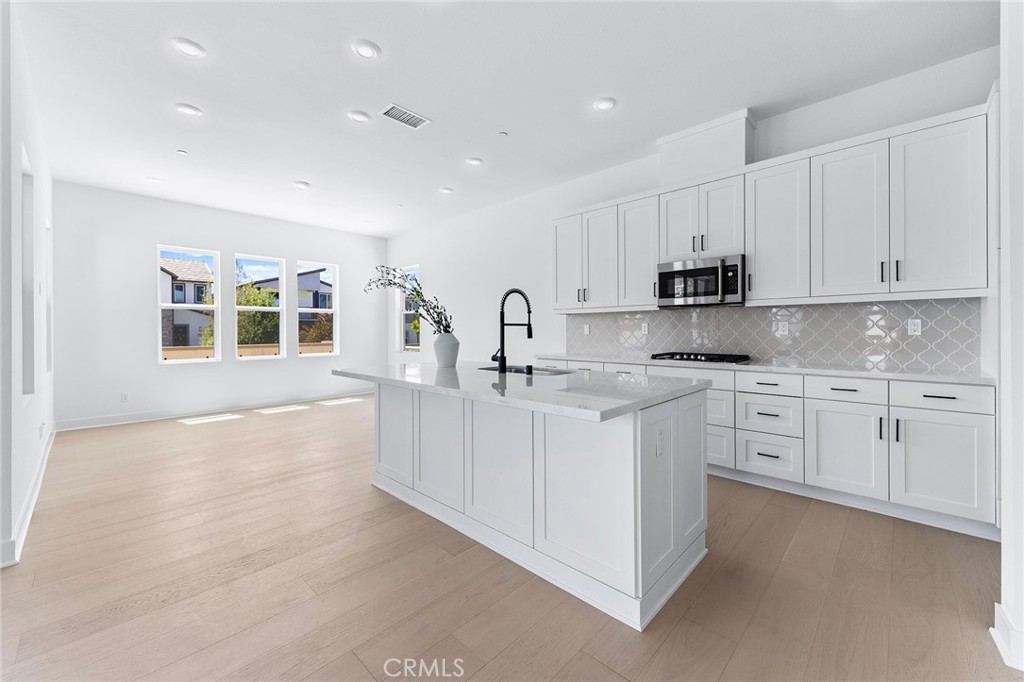 123 Bosal Irvine, CA 92618 - Photo 16 of 75 a kitchen with white cabinets and sink