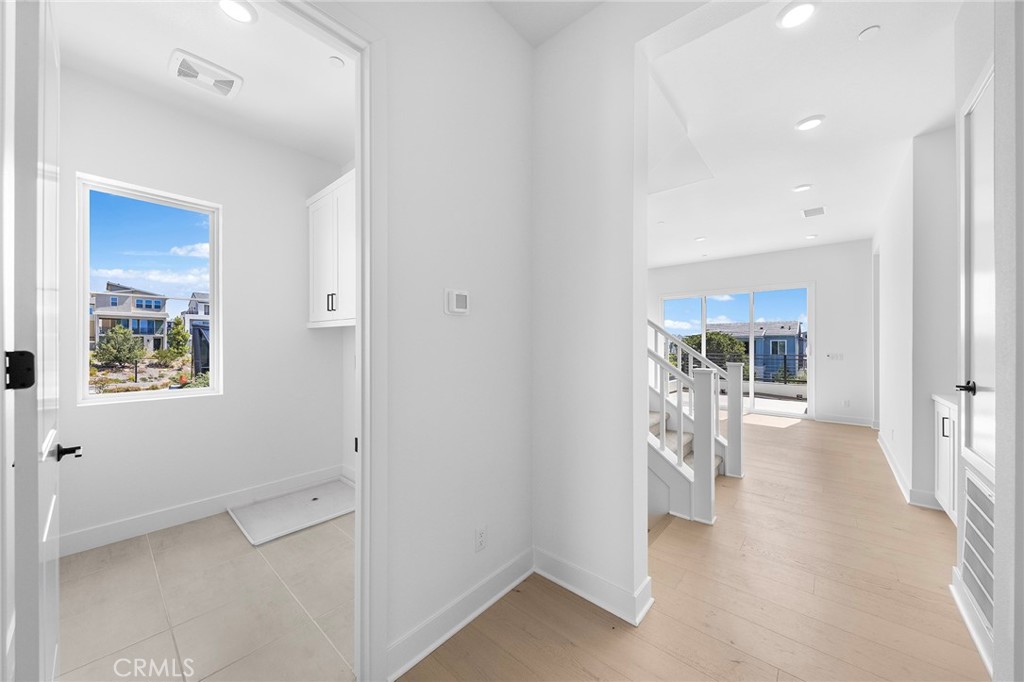 123 Bosal Irvine, CA 92618 - Photo 48 of 75 a view of a hallway with a dining table and chairs