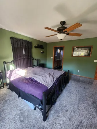 a bedroom with a bed and a mirror