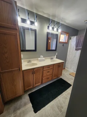 a bathroom with a sink double vanity and a mirror