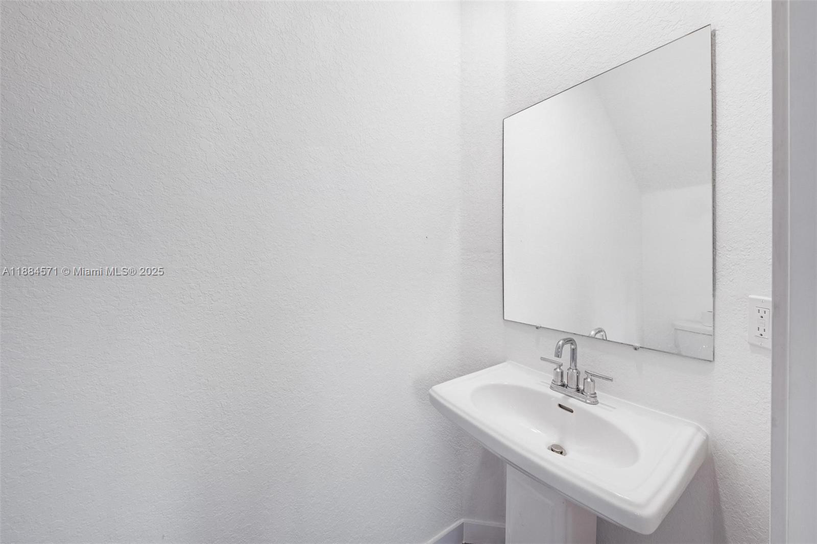 186 Southeast 5th Court, Unit 186 Deerfield Beach, FL 33441 - Photo 2 of 10 a bathroom with a sink and a mirror
