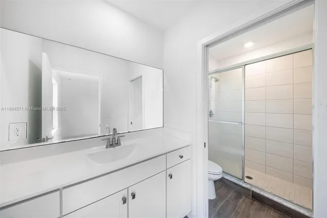 a bathroom with a shower and a sink