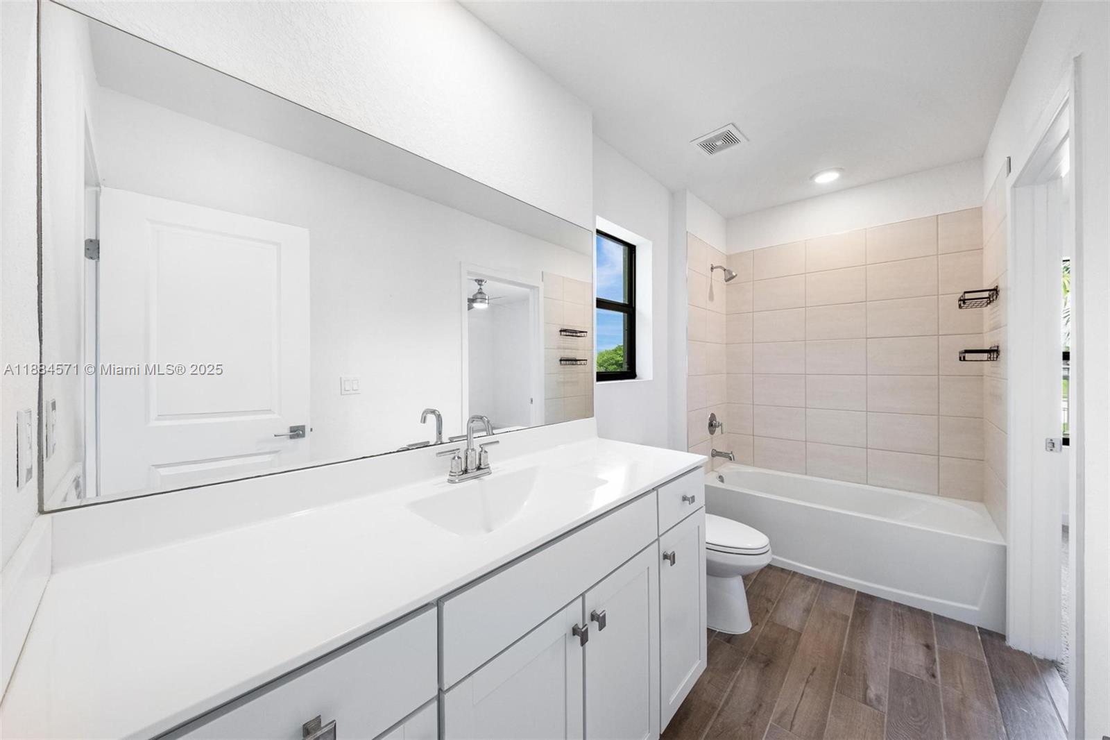 186 Southeast 5th Court, Unit 186 Deerfield Beach, FL 33441 - Photo 8 of 10 a bathroom with a sink a toilet and shower