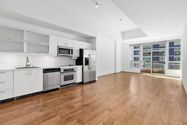 a view of kitchen with wooden floor and electronic appliances