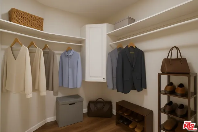 a view of walk in closet with clothes and shoes