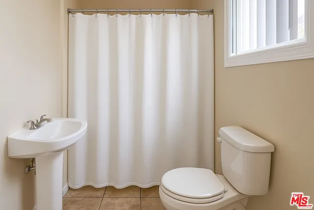 a white toilet sitting next to a white sink