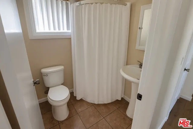 a white toilet sitting next to a sink