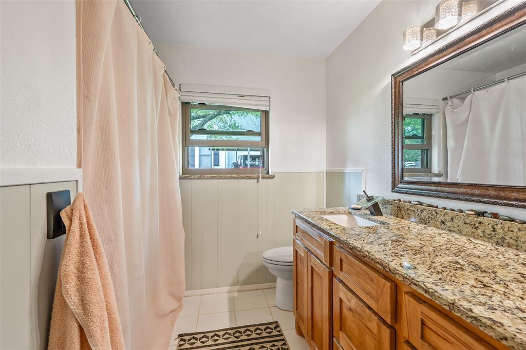 621 Athens Street Canton, TX 75103 - Photo 11 of 25 a bathroom with a sink a toilet and a window